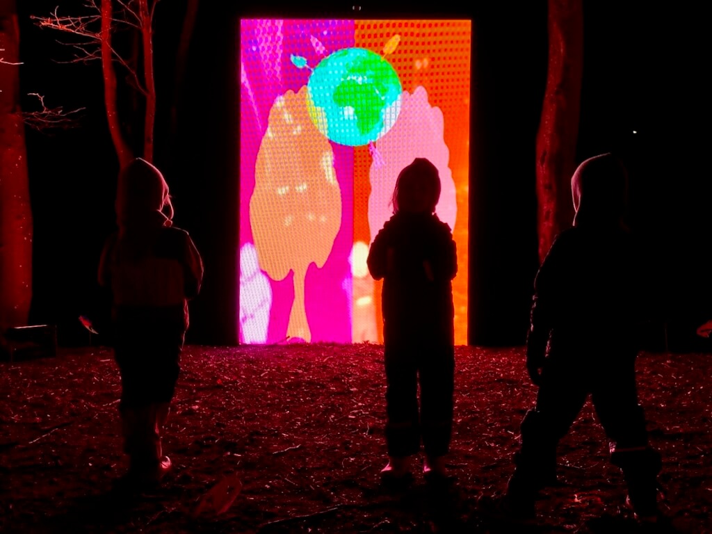 3 kids in a forest get ready to play with Be a Tree.