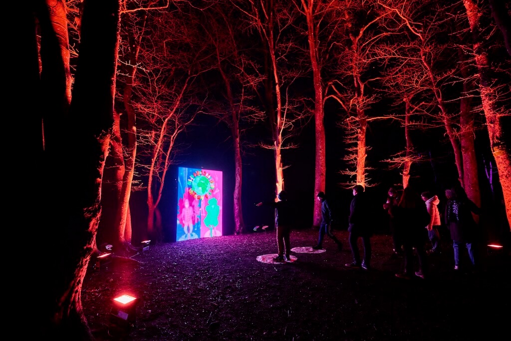 Families queue to interact with Tine's Be A Tree, using their bodies to create shapes that are then captured through cameras and turned into trees.
