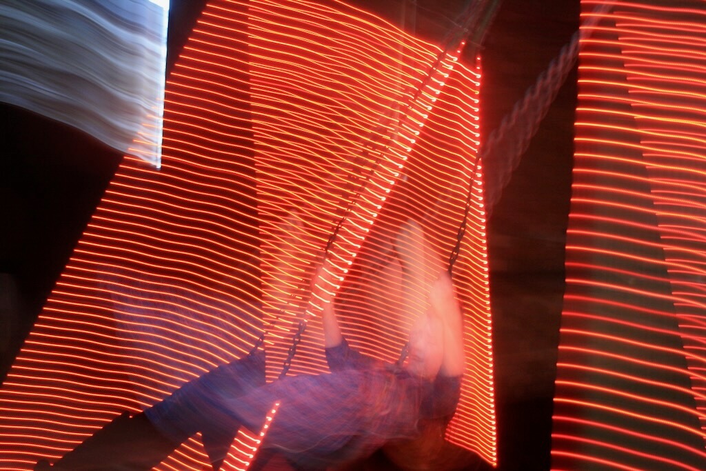 Bright orange light trails create an abstract long exposure.
