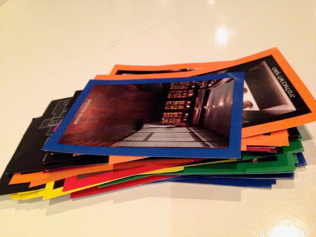 Small cards depict artworks in a gallery that game participants need to find.