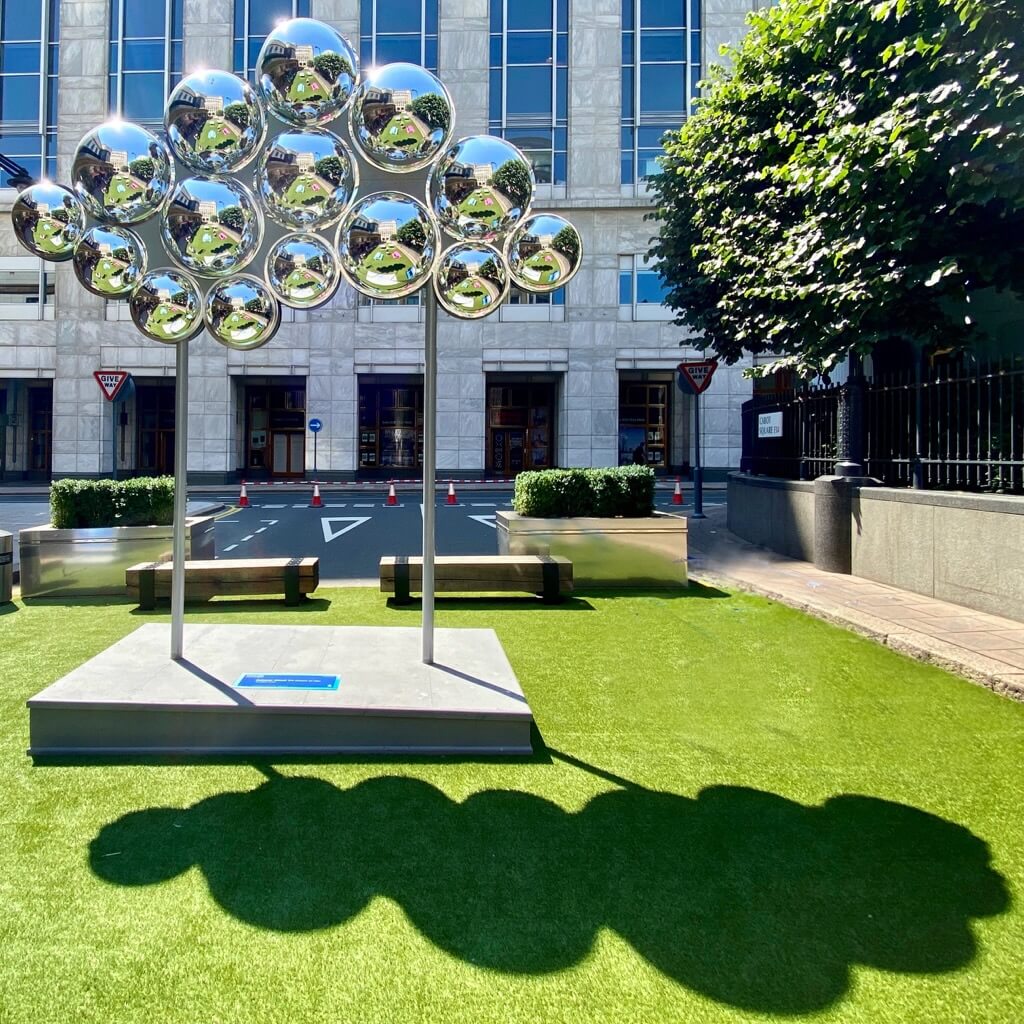 Bright sunlight creates a gorgeous cloud shaped shadow from Tine's large sculpture.