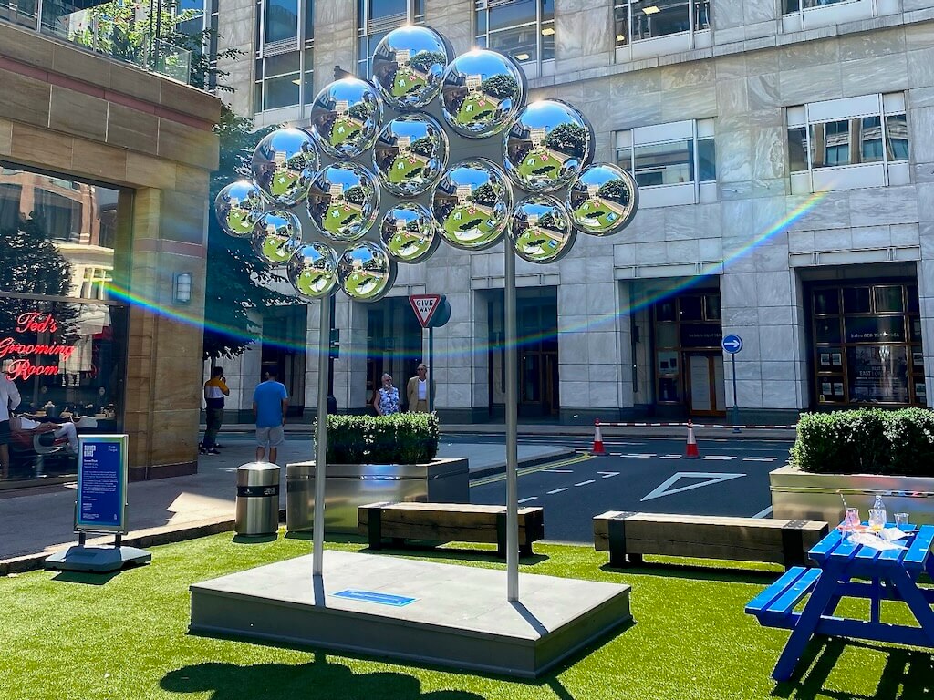 The reflective cloud shaped statue creates a rainbow where sunlight is reflected at interesting angles.