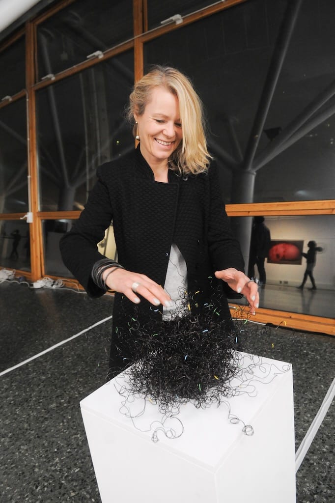 Tine Bech plays with her black wire sculpture, creating noise through activating strands of wire.