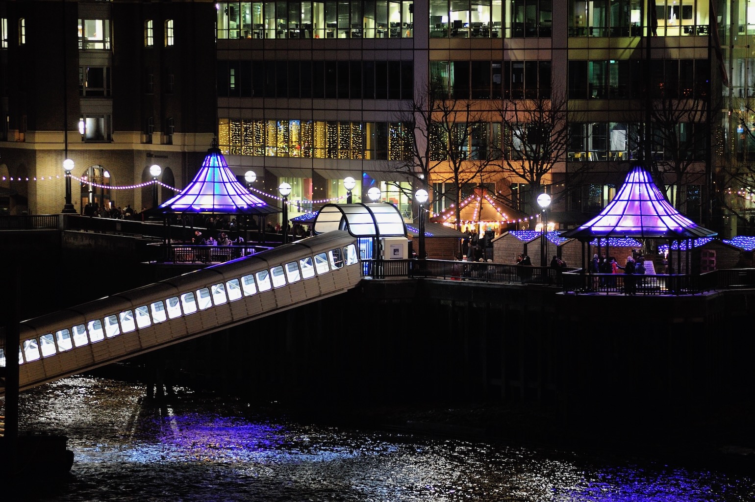 Pedestrians in London take selfies with the beautifully lit pavilions in purple.
