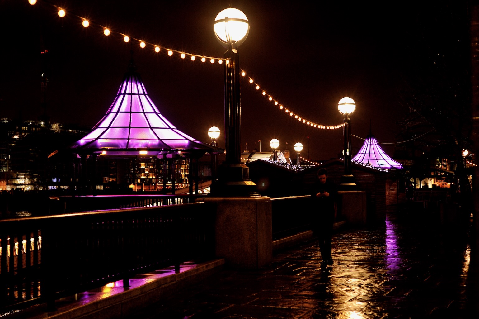 Alight in baby pink, pavilions stand out in the night.