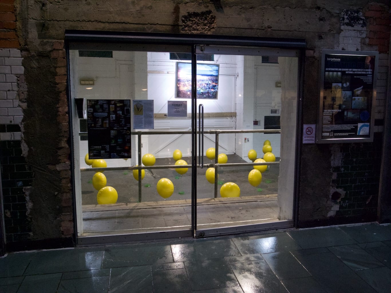 Bright yellow balloons await exhibition visitors to activate their sounds.