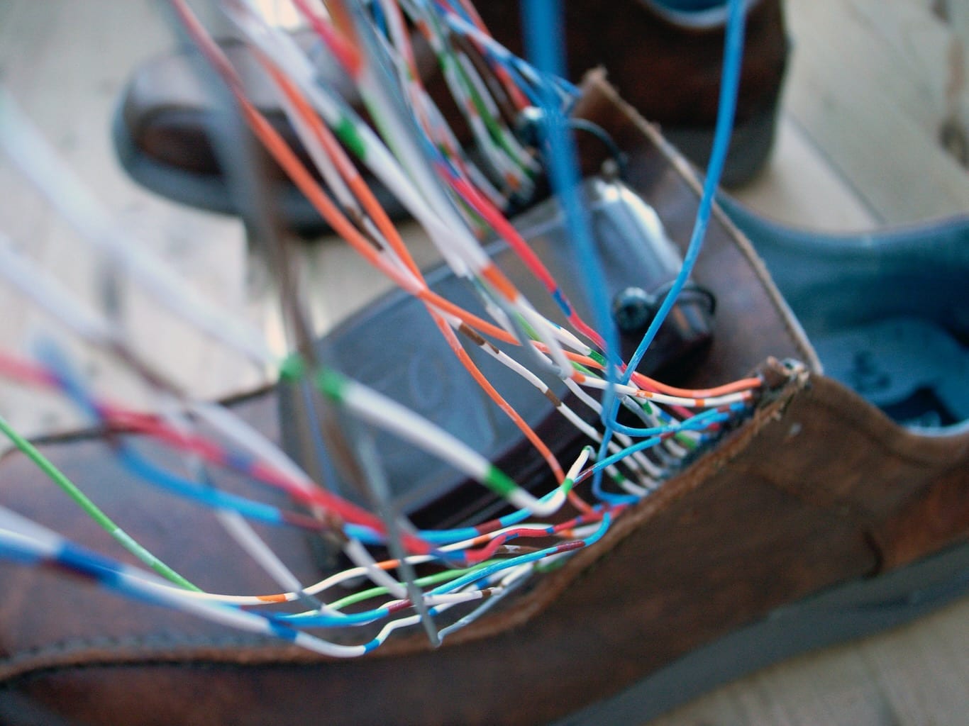A closeup of a shoe adorned with sensitive wires that activate sounds based on where they are in the 3D space.