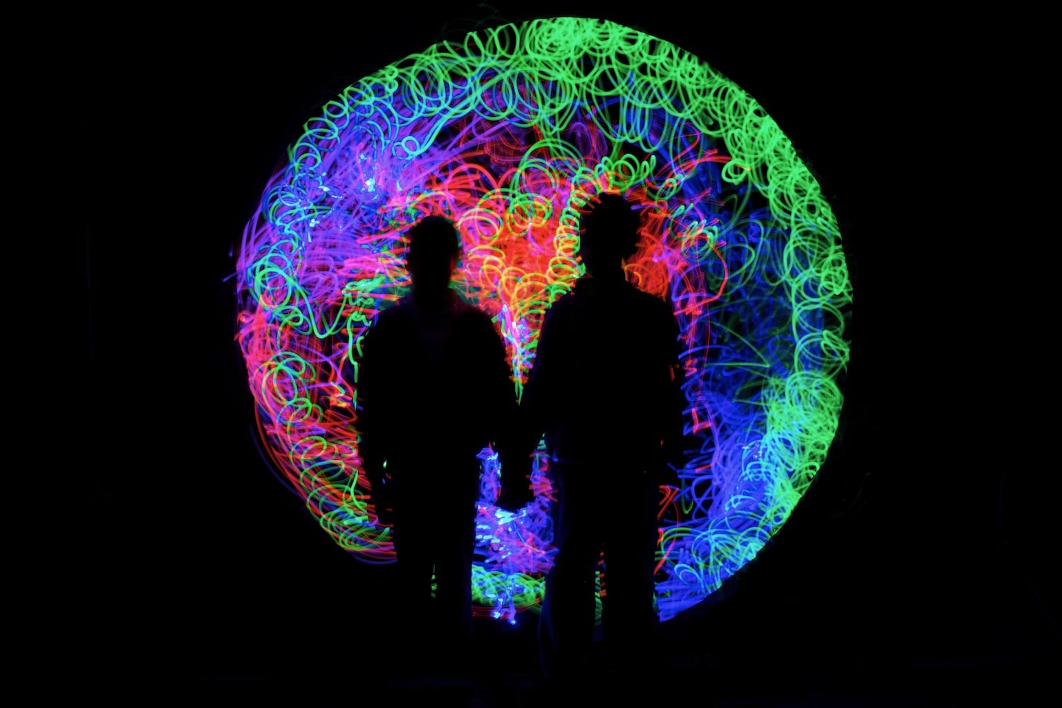 A light painted portrait created in Tine's workshop, featuring a swirl of bright colours and two silhouettes.