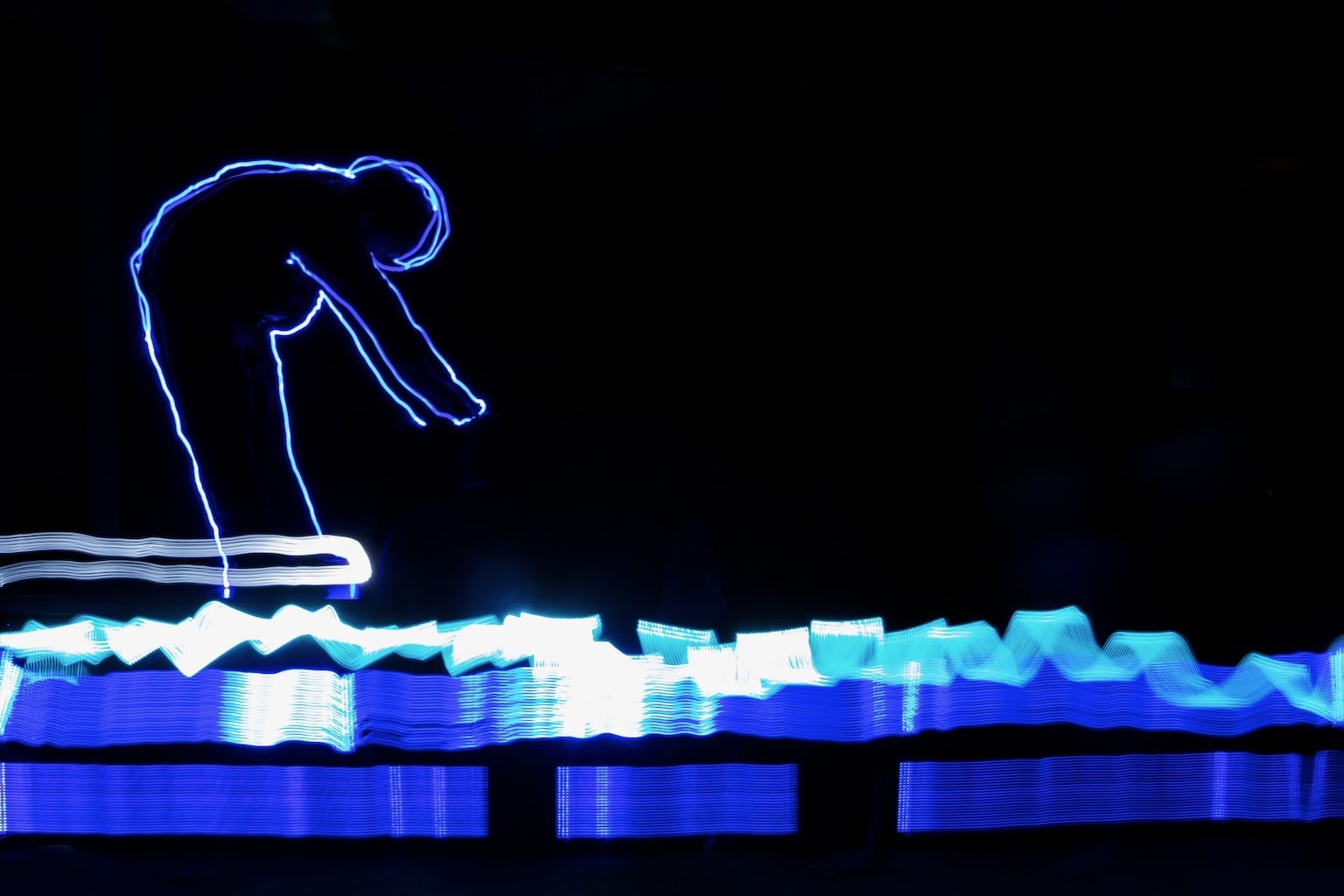 A light drawing of a diver ready to jump into a pool of blue light trails.