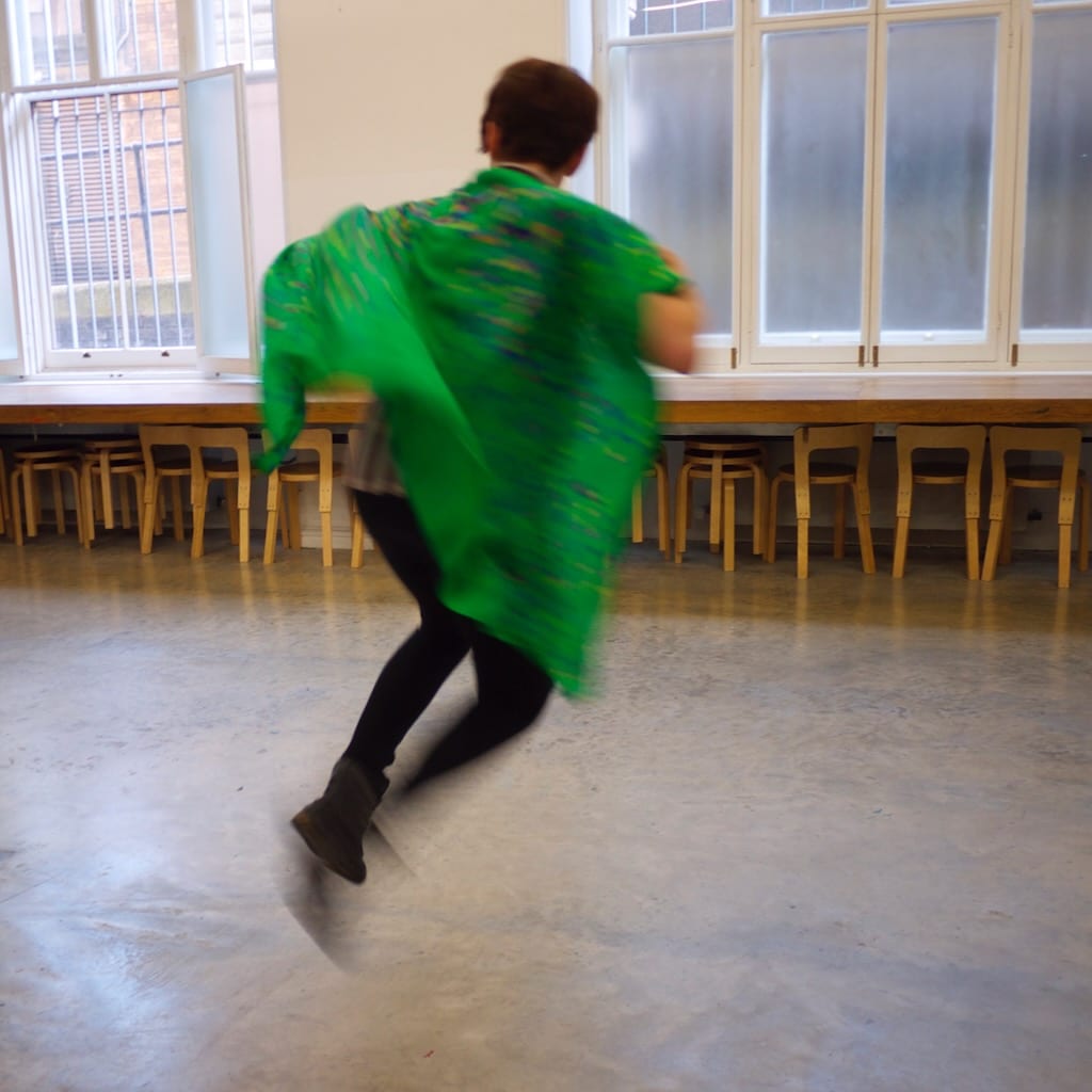 A workshop participant leaps with excitment.