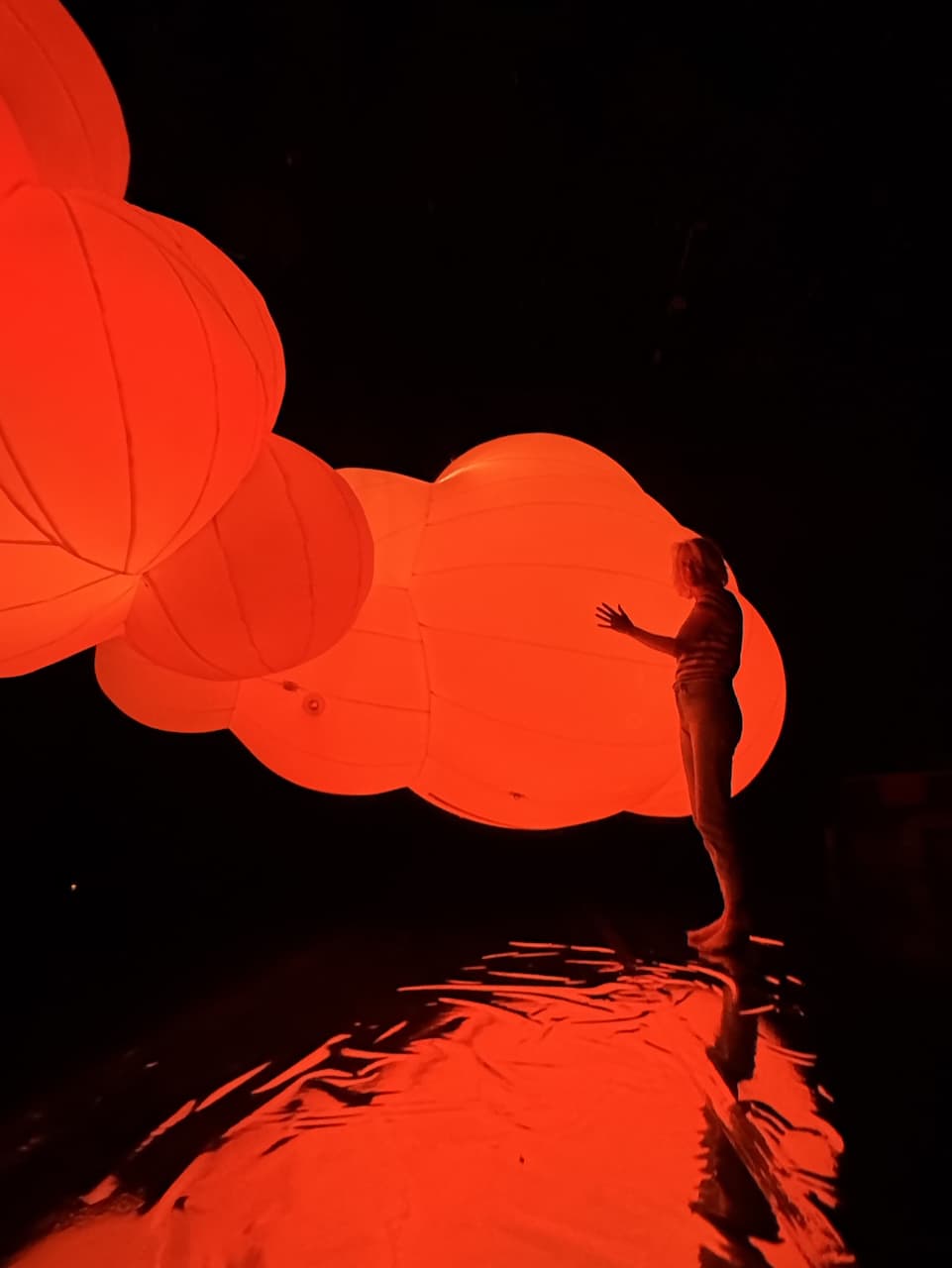 Tine by her giant floating luminous cloud created by Tine Bech Studio.